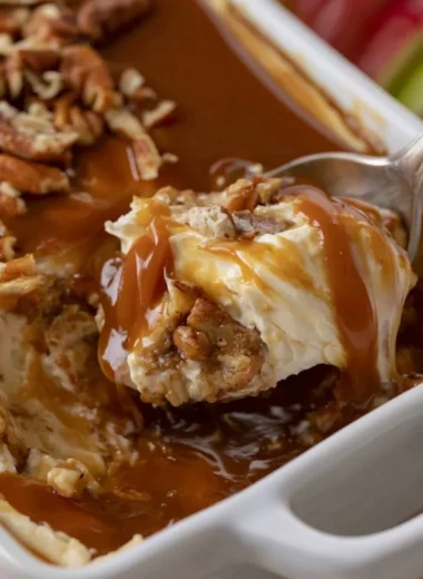 Delicious caramel apple cheesecake dip served in a bowl with apple slices
