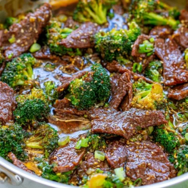 Cozy beef and broccoli dish served in a bowl with fresh vegetables.