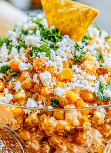 Delicious Mexican street corn dip served in a bowl with toppings