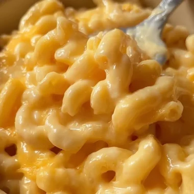 Cozy microwave macaroni and cheese in a bowl, topped with melted cheese.