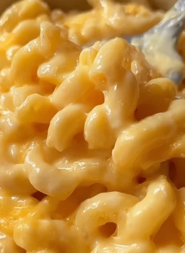 Cozy microwave macaroni and cheese in a bowl, topped with melted cheese.
