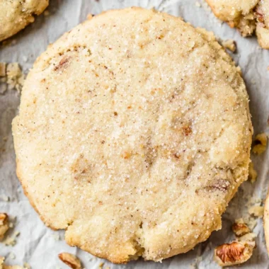 Delicious pecan sandies cookies decorated with nuts on a wooden table
