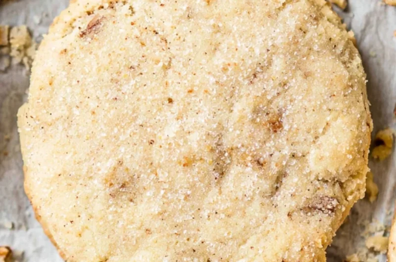Delicious pecan sandies cookies decorated with nuts on a wooden table