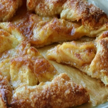 Delicious rustic French apple tart fresh out of the oven, topped with apples.