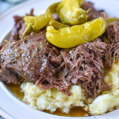 Whole30 Mississippi Pot Roast served on a plate with fresh herbs