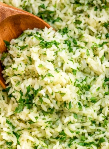 Cozy cilantro lime rice served in a bowl with fresh cilantro and lime slices