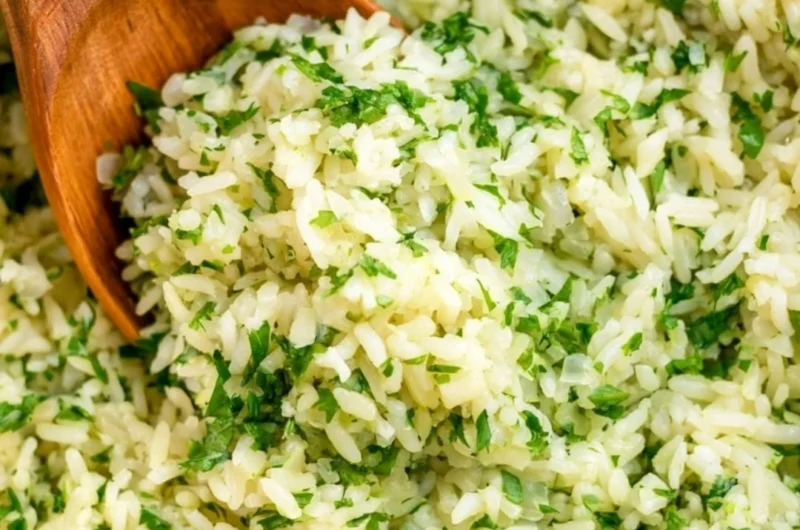 Cozy cilantro lime rice served in a bowl with fresh cilantro and lime slices
