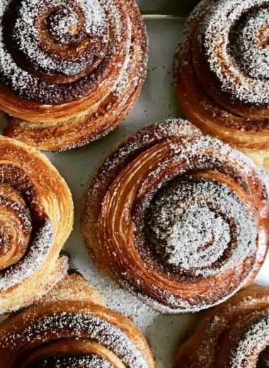 Freshly baked Cardamom Sugar Buns with a golden brown crust and aromatic spices.