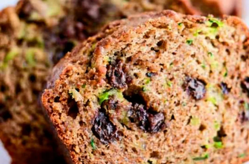 Loaf of chocolate chip zucchini bread with chocolate chips and fresh zucchini