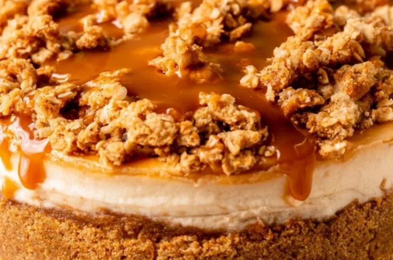 Delicious apple crumble cheesecake topped with a buttery crumble and fresh apples.