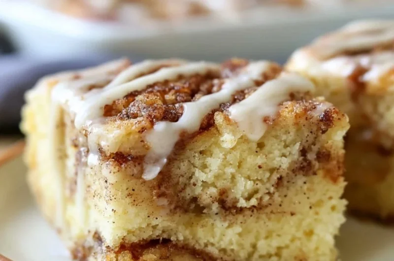 Cozy cinnamon roll cake fresh out of the oven, topped with creamy frosting.