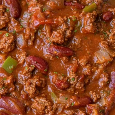 Bowl of cozy easy chili with toppings like cheese and cilantro