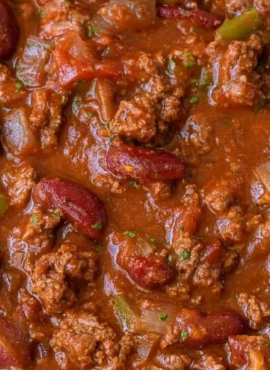 Bowl of cozy easy chili with toppings like cheese and cilantro