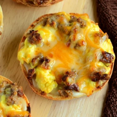 Cozy English muffin breakfast pizza topped with cheese and toppings