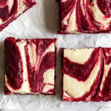 Cozy red velvet cheesecake brownies topped with cream cheese frosting.