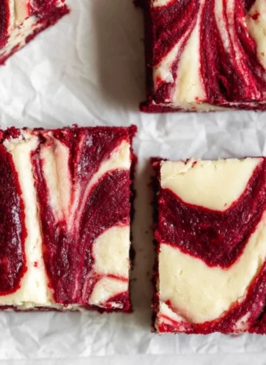 Cozy red velvet cheesecake brownies topped with cream cheese frosting.