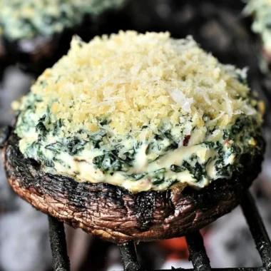 Grilled spinach dip-stuffed portabella mushrooms, a delicious appetizer.