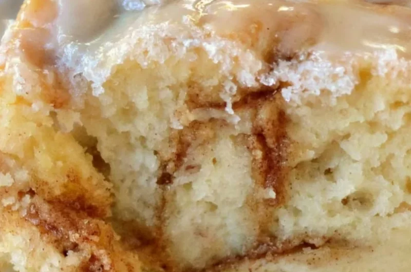 Homemade cinnamon roll cake topped with icing and cinnamon swirl