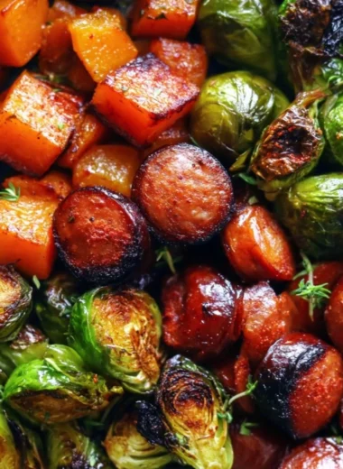 Cozy sausage skillet with butternut squash and Brussels sprouts dish on a wooden table