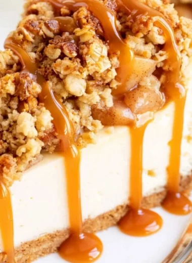 Delicious Apple Crisp Cheesecake topped with spiced apple topping