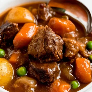 Cozy slow cooker beef stew served in a bowl with fresh herbs