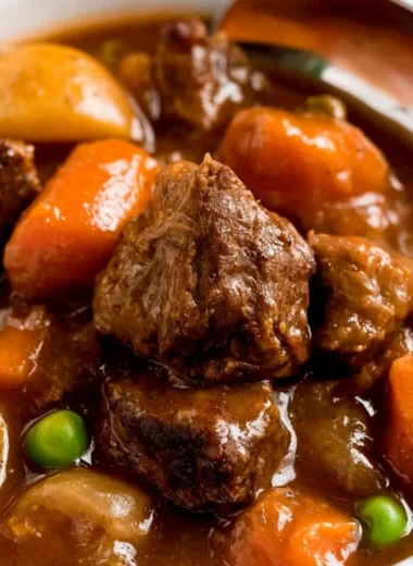 Cozy slow cooker beef stew served in a bowl with fresh herbs