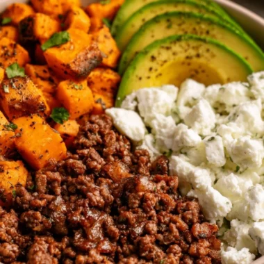 Hot Honey Sweet Potato Beef Bowls topped with fresh herbs and spices