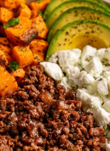 Hot Honey Sweet Potato Beef Bowls topped with fresh herbs and spices
