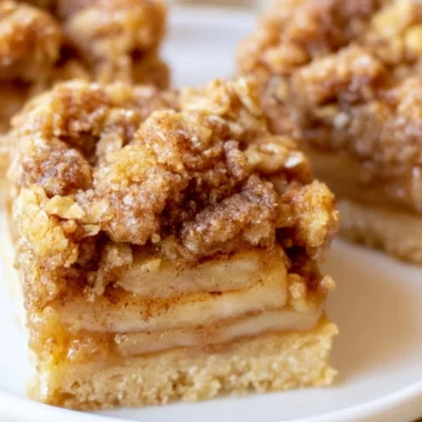 Delicious warm apple pie bars topped with cinnamon and sugar