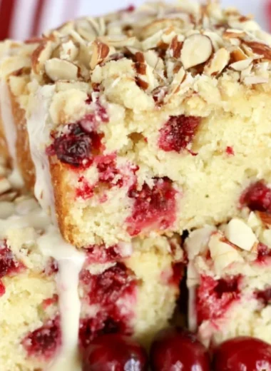 Delicious Cranberry Almond Cake topped with fresh cranberries and almonds