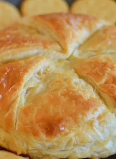 Tasty Baked Brie in Puff Pastry served with fruits and nuts.