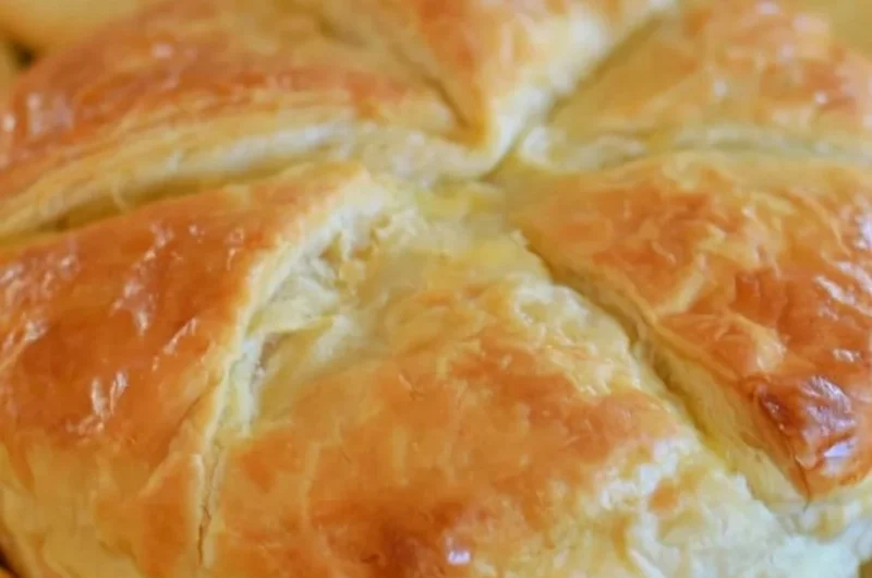 Tasty Baked Brie in Puff Pastry served with fruits and nuts.