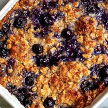 Delicious blueberry baked oatmeal topped with fresh blueberries and almonds.