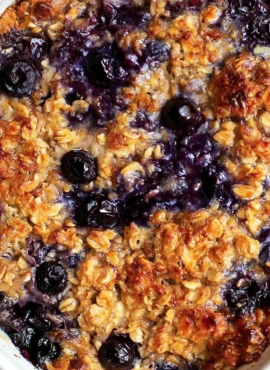 Delicious blueberry baked oatmeal topped with fresh blueberries and almonds.