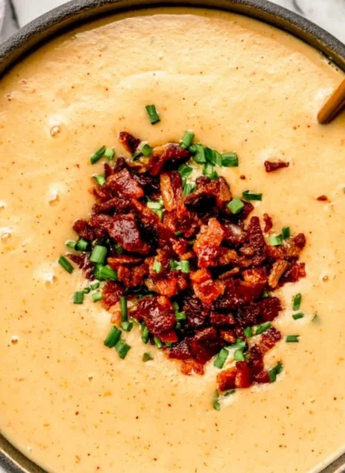 Bowl of high-protein cream of potato soup with herbs and toppings