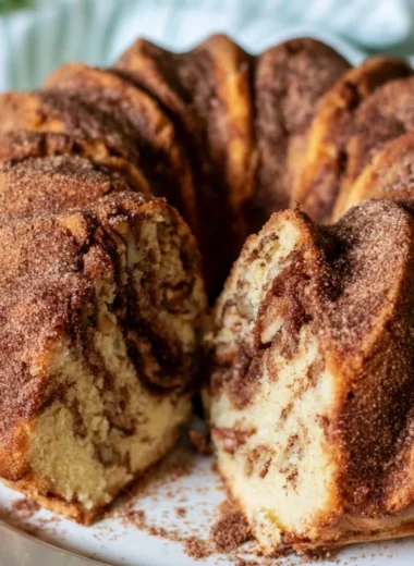 Moist cinnamon coffee cake served on a plate with a fork