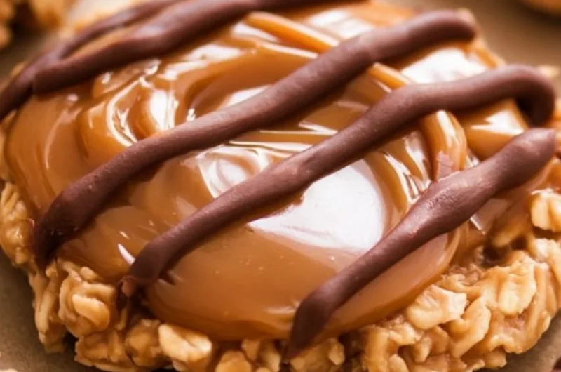 Delicious peanut butter chocolate caramel cookies stacked on a plate.
