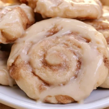 Plate of soft cinnamon roll cookies with icing on top