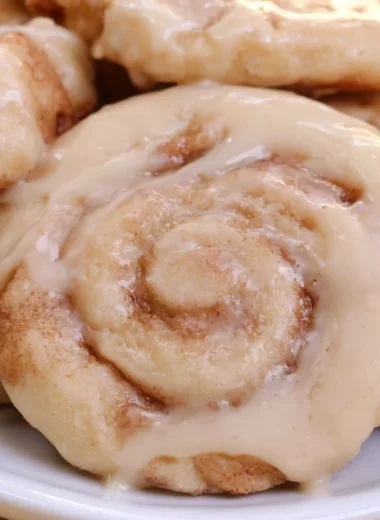 Plate of soft cinnamon roll cookies with icing on top