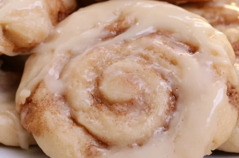 Plate of soft cinnamon roll cookies with icing on top