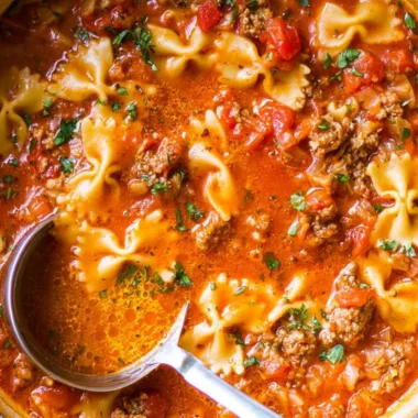 Bowl of the world's best lasagna soup with cheese and herbs