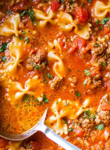 Bowl of the world's best lasagna soup with cheese and herbs