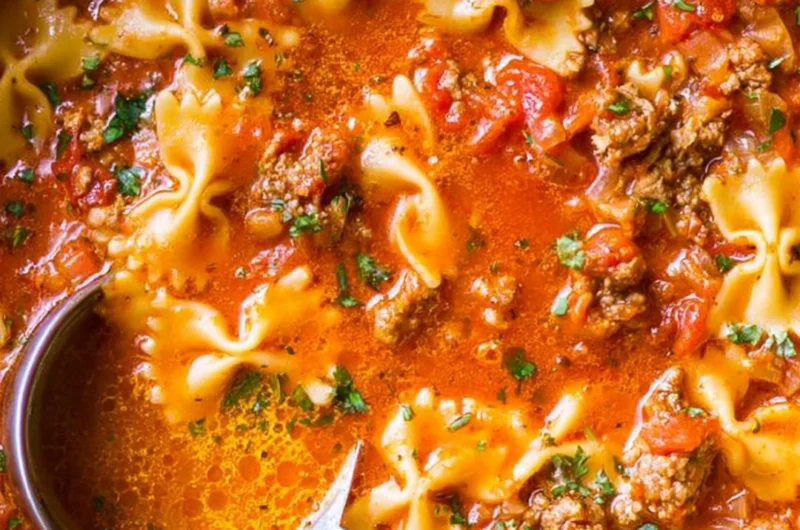 Bowl of the world's best lasagna soup with cheese and herbs